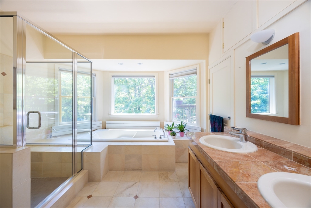 51 Naples Road Brookline, MA 02446 - Photo 6 of 16 a bathroom with a granite countertop tub and a sink
