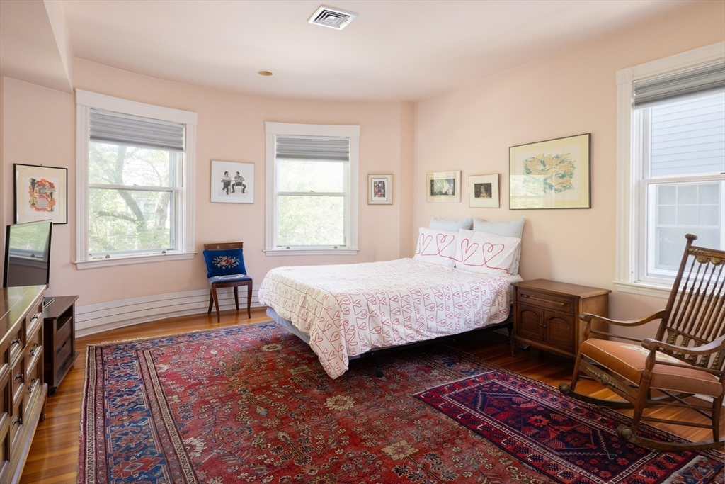 51 Naples Road Brookline, MA 02446 - Photo 9 of 16 a bedroom with a bed and wooden floor
