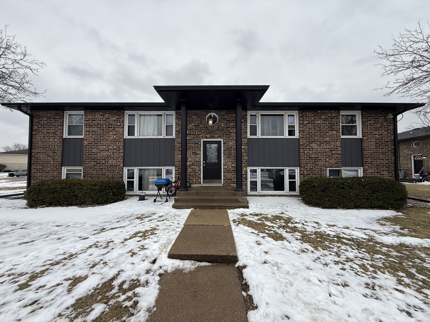 382 North Birch Street Manteno, IL 60950 - Photo 1 of 15 a view of a house with a yard covered in snow