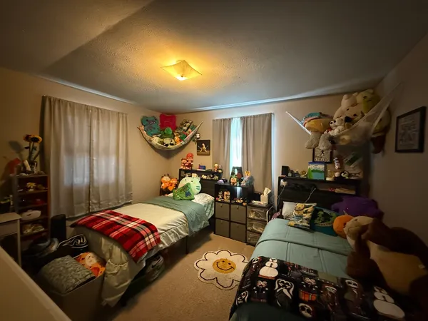 a bedroom with furniture and a flat screen tv