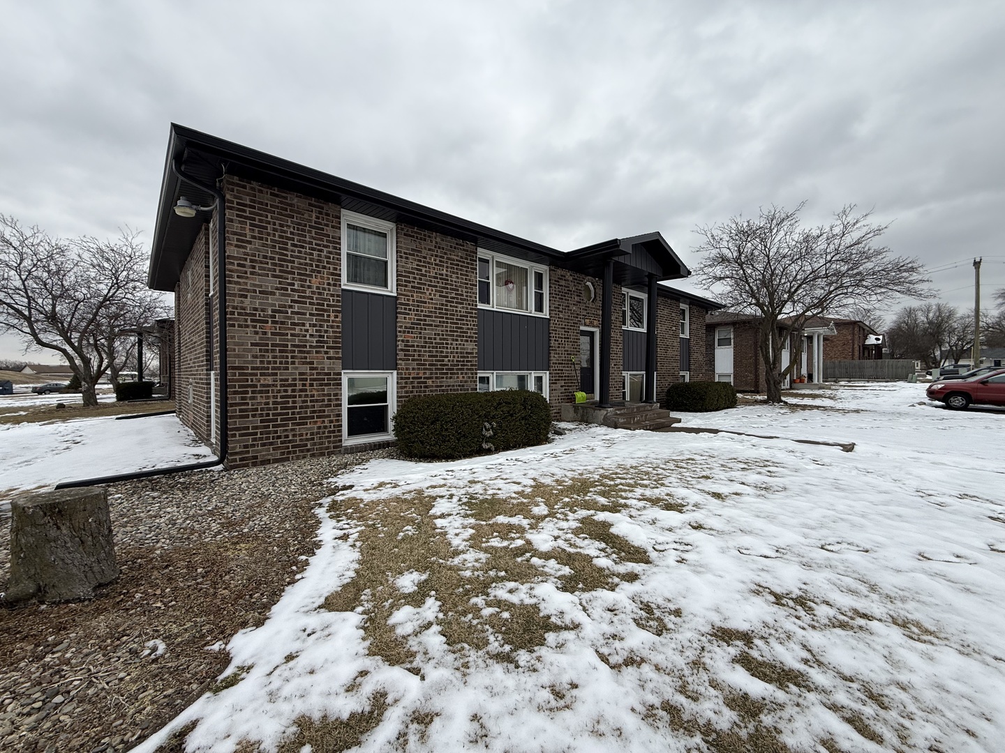 382 North Birch Street Manteno, IL 60950 - Photo 3 of 15 a front view of a house with a yard covered in snow