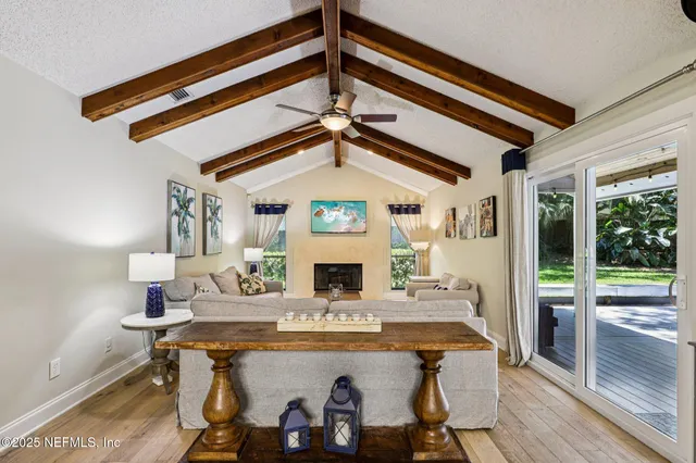 a living room with fireplace furniture and a wooden floor