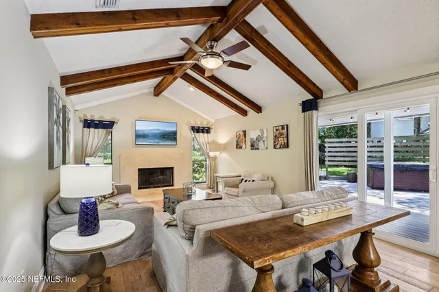 a living room with furniture a fireplace and a flat screen tv