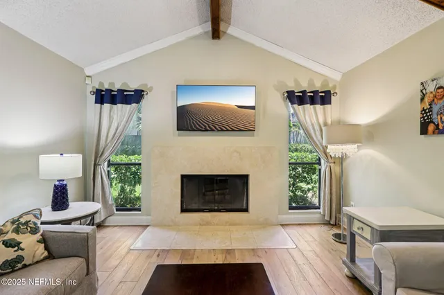 a living room with furniture and a ceiling fan