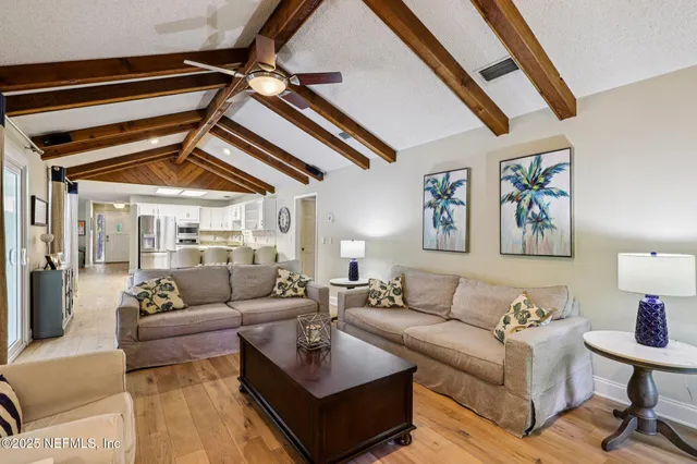 a living room with furniture and a ceiling fan
