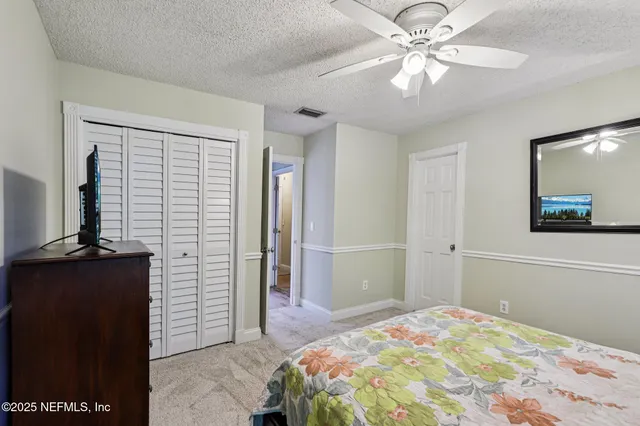 a bed room with a bed and a television