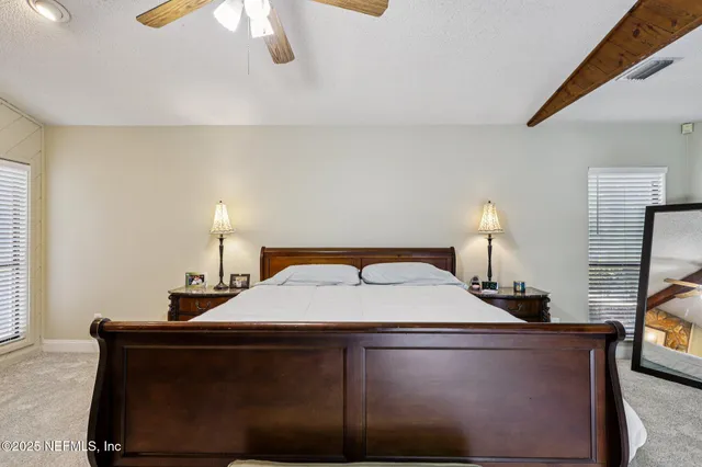 a bedroom with a bed and a mirror