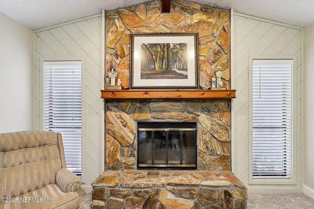 a large bedroom with a large bed and a chandelier