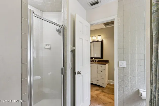a bathroom with a granite countertop sink a toilet and a mirror