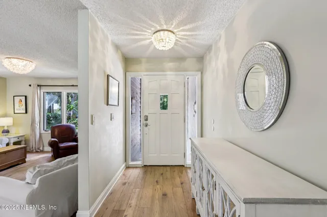 a living room with furniture a table and a large window
