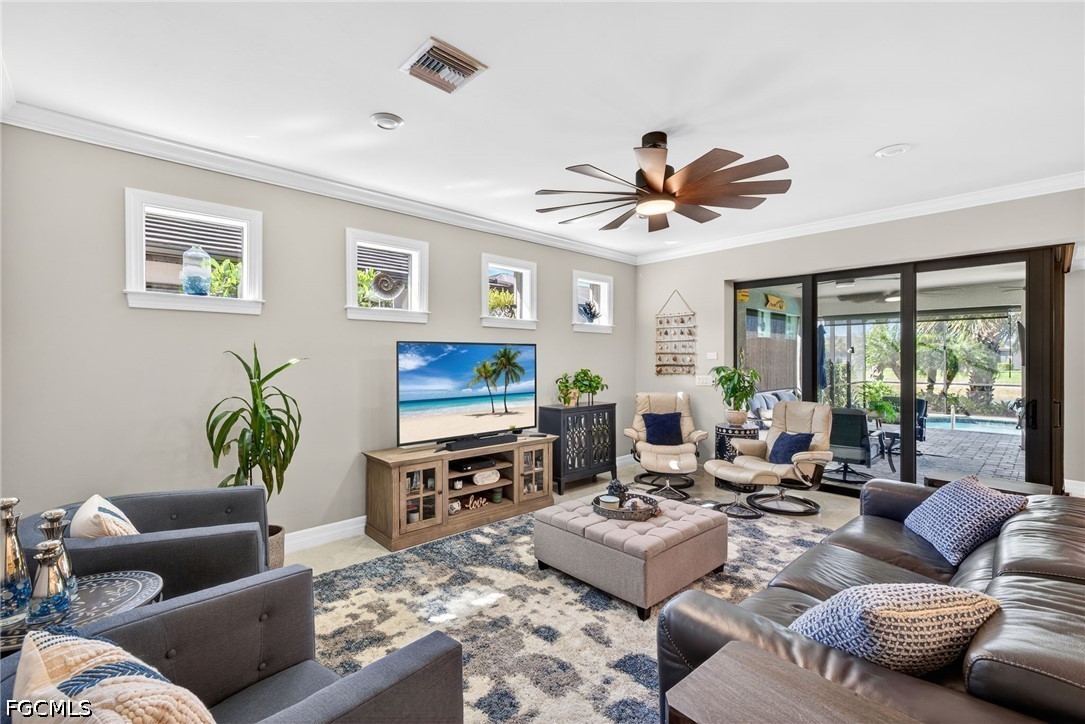 11932 Bourke Place Fort Myers, FL 33913 - Photo 13 of 44 a living room with furniture a large window and a flat screen tv