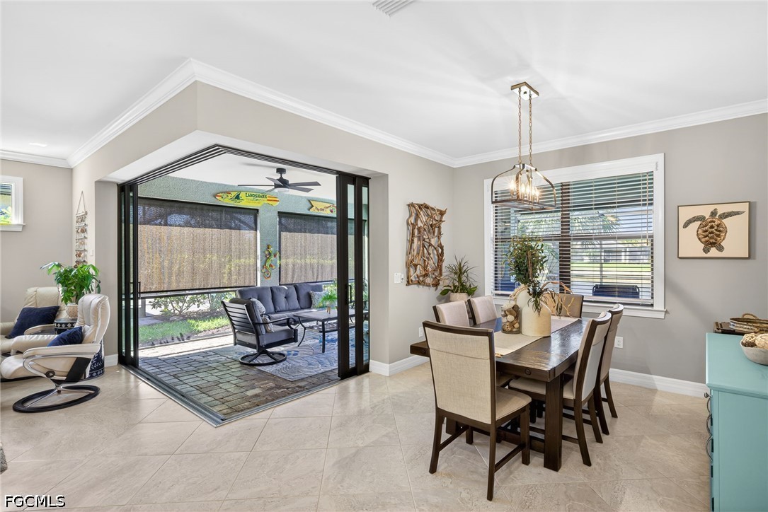 11932 Bourke Place Fort Myers, FL 33913 - Photo 14 of 44 a dining room with furniture a chandelier and wooden floor