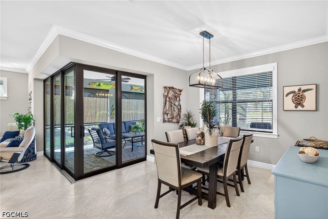 11932 Bourke Place Fort Myers, FL 33913 - Photo 17 of 44 a dining room with furniture a chandelier and wooden floor
