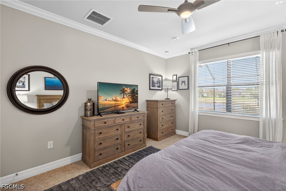 11932 Bourke Place Fort Myers, FL 33913 - Photo 19 of 44 a bedroom with a bed and a chandelier