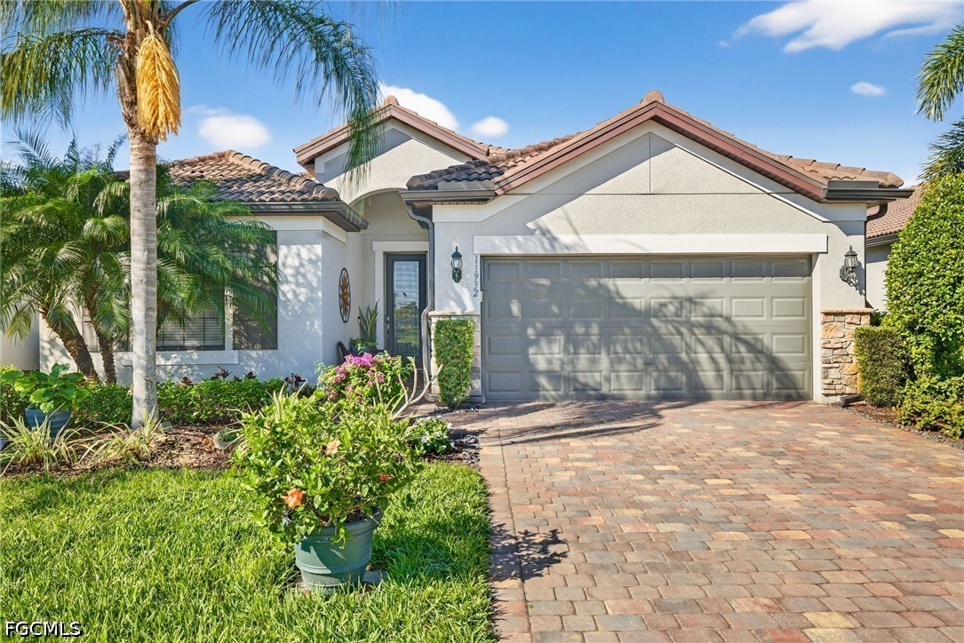 11932 Bourke Place Fort Myers, FL 33913 - Photo 2 of 44 a front view of a house with a yard and garage