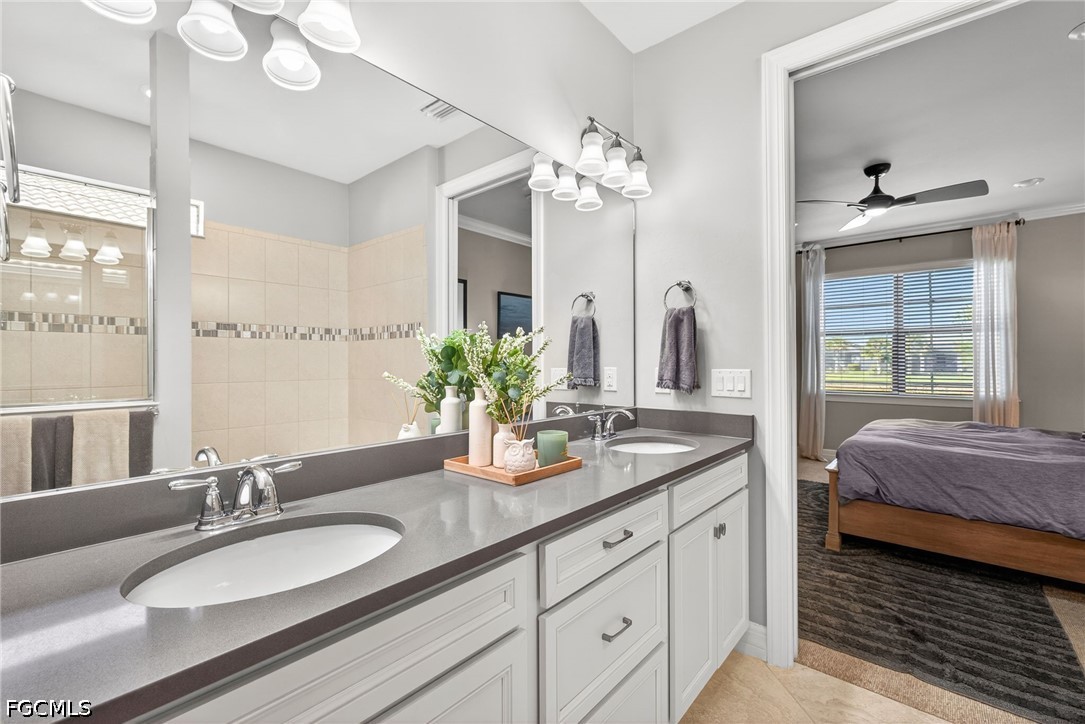 11932 Bourke Place Fort Myers, FL 33913 - Photo 23 of 44 a en suite bathroom with double vanity and a mirror