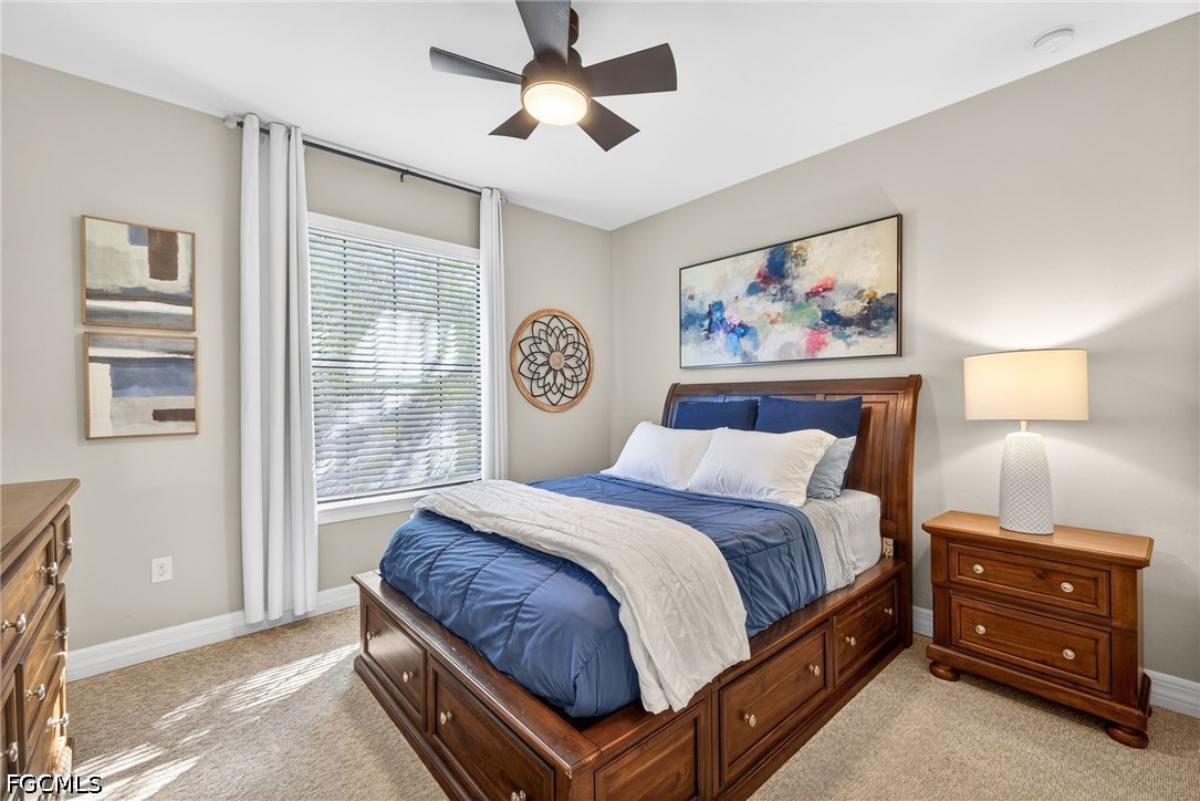 11932 Bourke Place Fort Myers, FL 33913 - Photo 24 of 44 a bedroom with a bed and a window