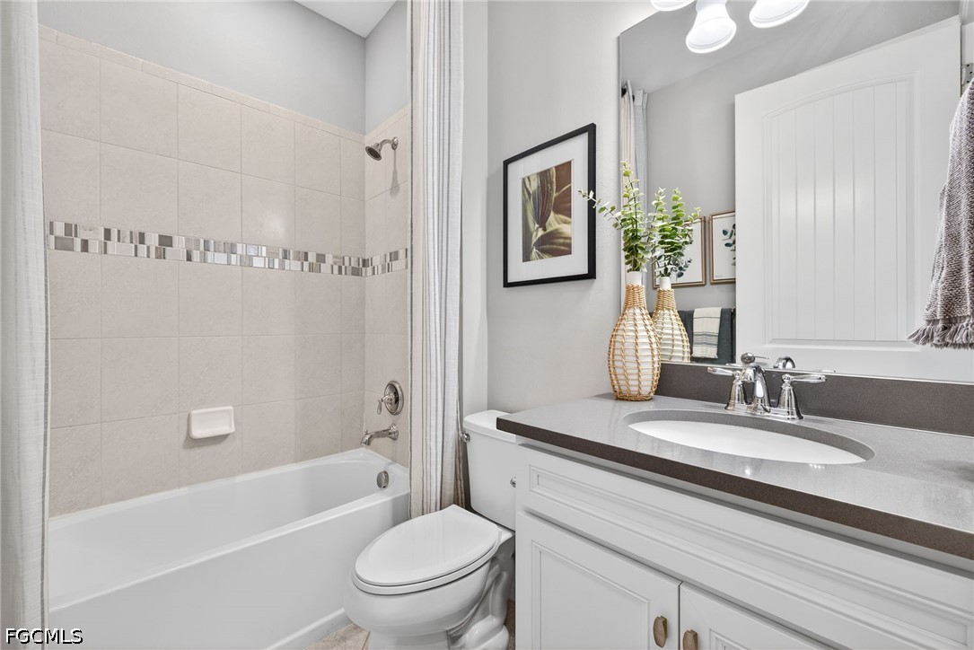 11932 Bourke Place Fort Myers, FL 33913 - Photo 25 of 44 a bathroom with a granite countertop sink a toilet a mirror and shower
