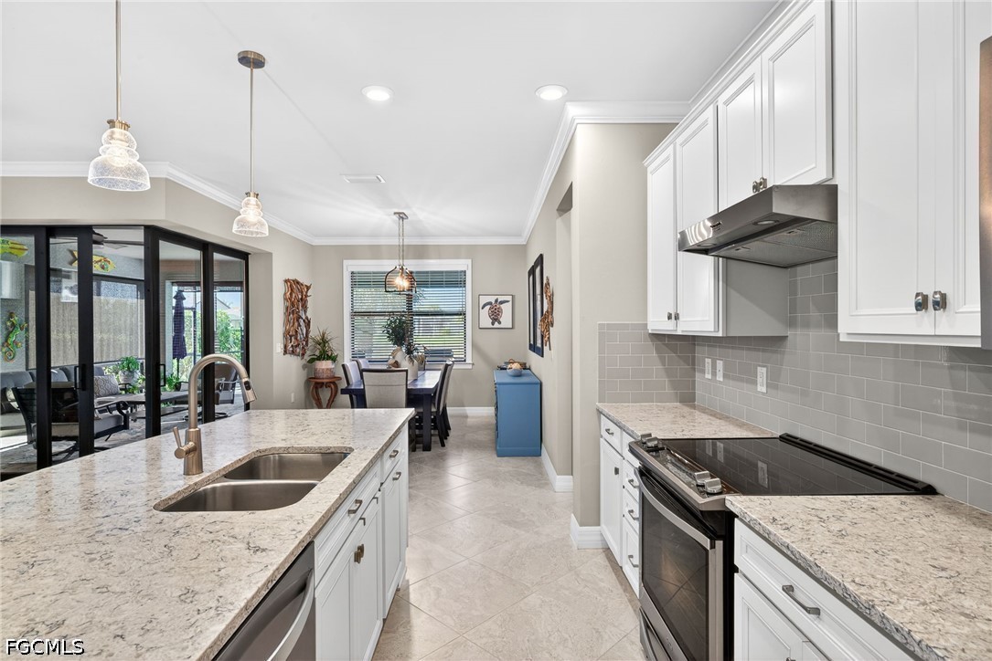 11932 Bourke Place Fort Myers, FL 33913 - Photo 6 of 44 a kitchen with stainless steel appliances granite countertop a sink a stove and a wooden floors