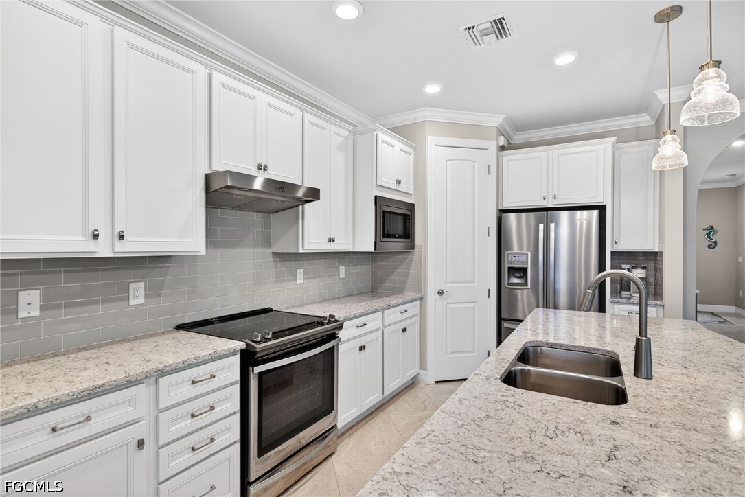 11932 Bourke Place Fort Myers, FL 33913 - Photo 7 of 44 a kitchen with granite countertop a sink stainless steel appliances and cabinets