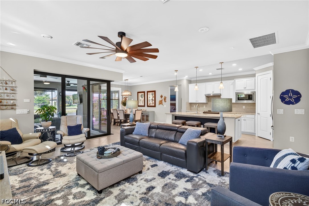 11932 Bourke Place Fort Myers, FL 33913 - Photo 10 of 44 a living room with furniture kitchen view and a large window