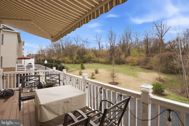 a view of a balcony with mountain view and wooden floor