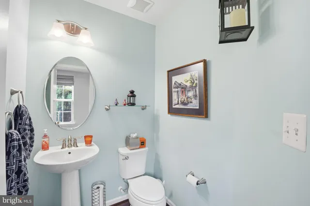 a bathroom with a toilet a sink and a mirror