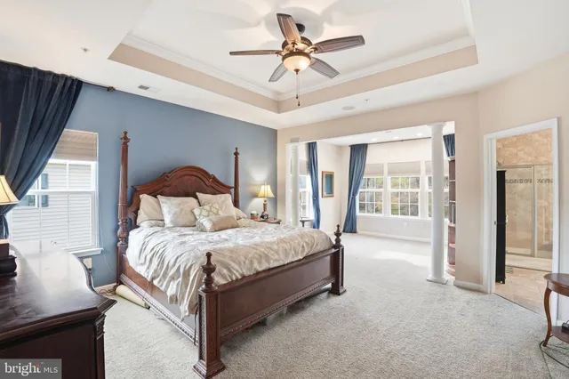 a bedroom with a large bed and a chandelier