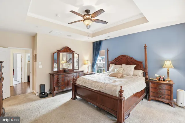 a bedroom with bed and a chandelier