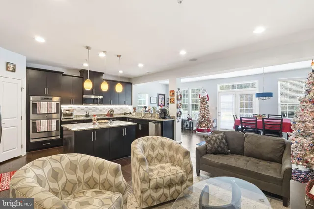 a living room with furniture and kitchen view