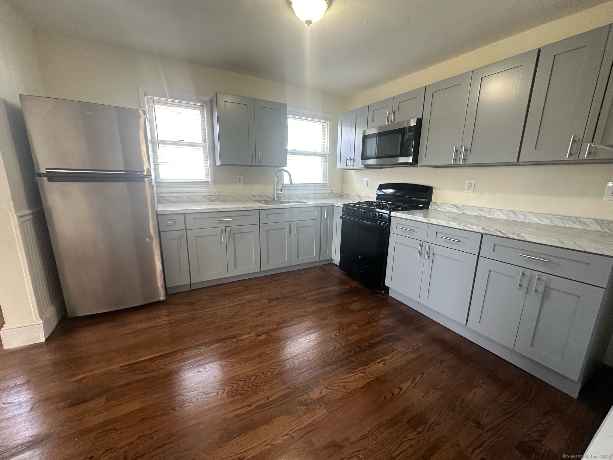 40 Vine Street, Unit 3 Bridgeport, CT 06604 - Photo 1 of 14 a kitchen with a refrigerator stove top oven and sink