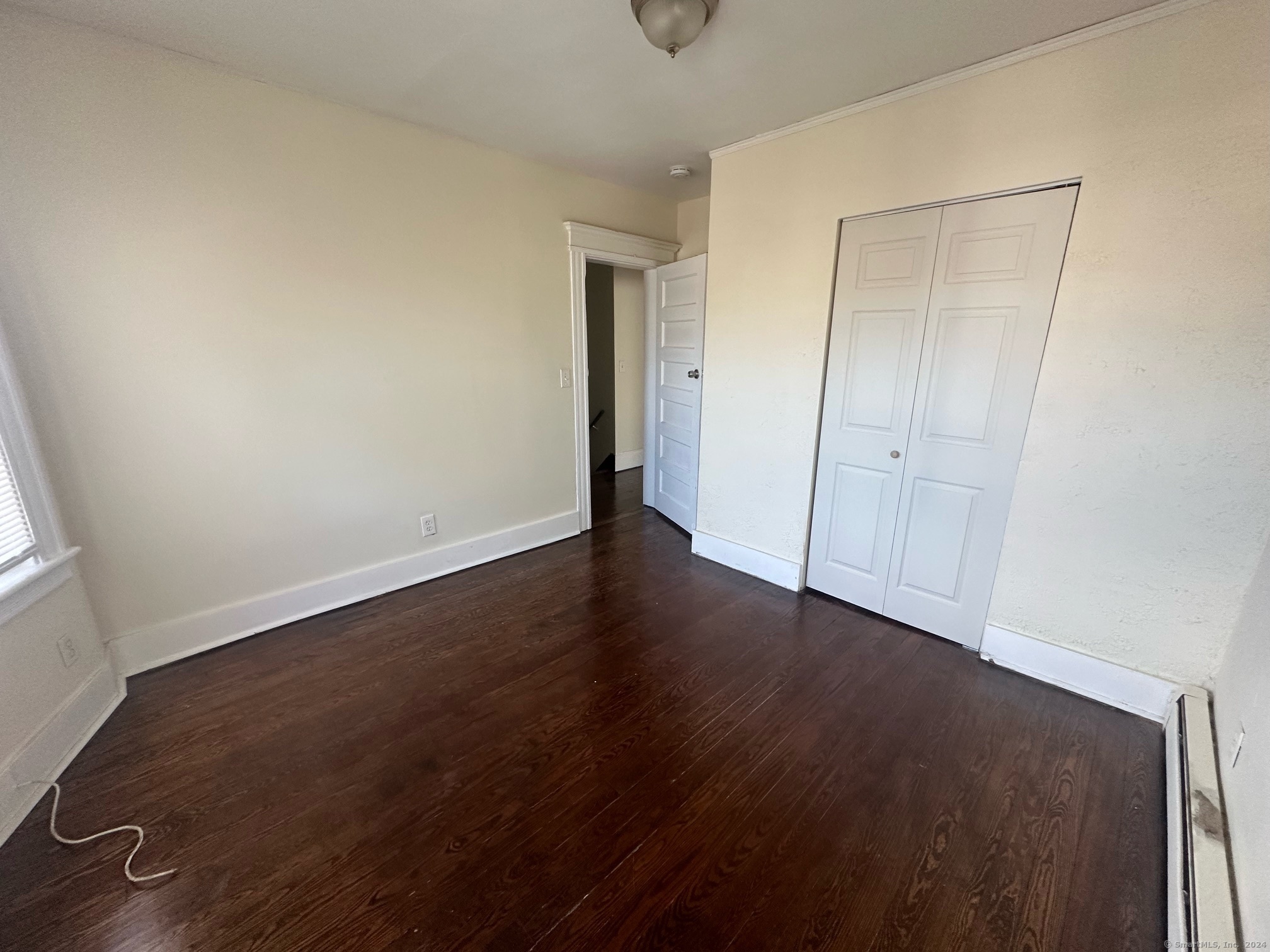 40 Vine Street, Unit 3 Bridgeport, CT 06604 - Photo 12 of 14 an empty room with wooden floor and closet