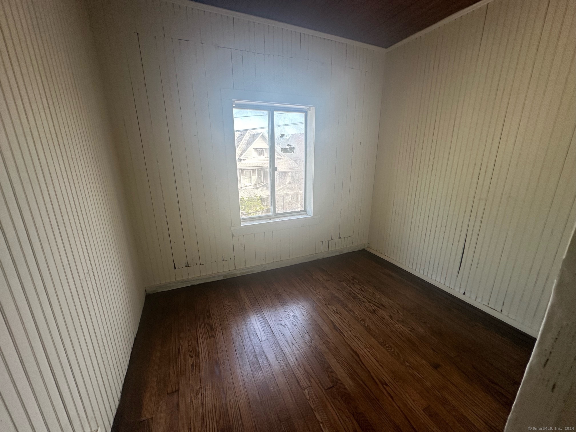 40 Vine Street, Unit 3 Bridgeport, CT 06604 - Photo 14 of 14 an empty room with wooden floor and windows