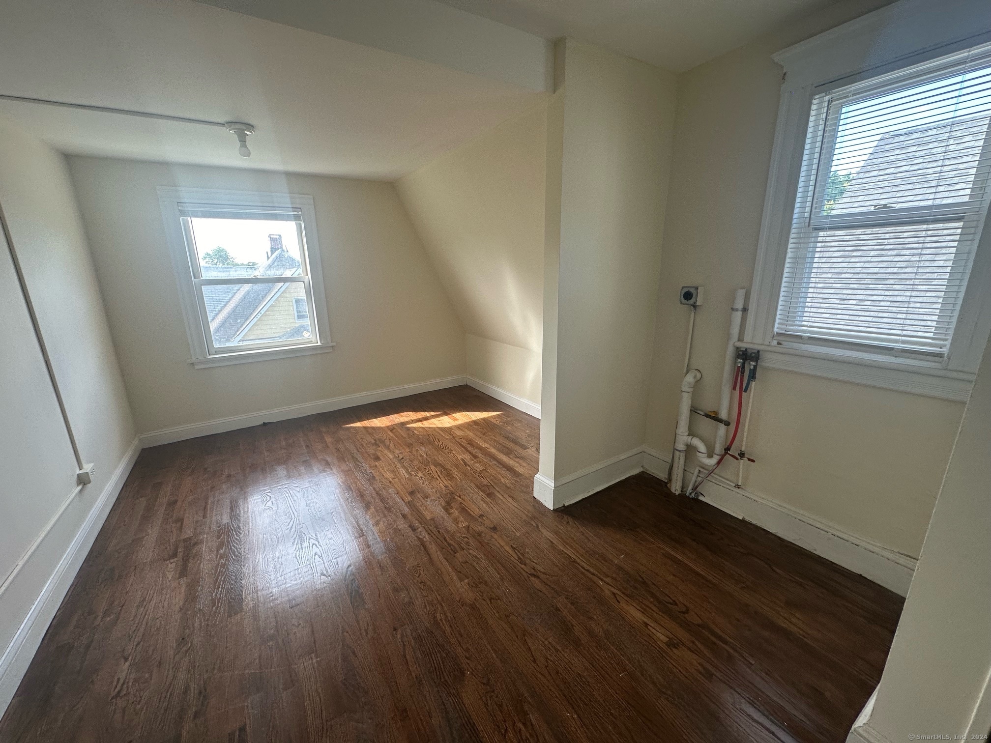 40 Vine Street, Unit 3 Bridgeport, CT 06604 - Photo 4 of 14 an empty room with wooden floor and windows