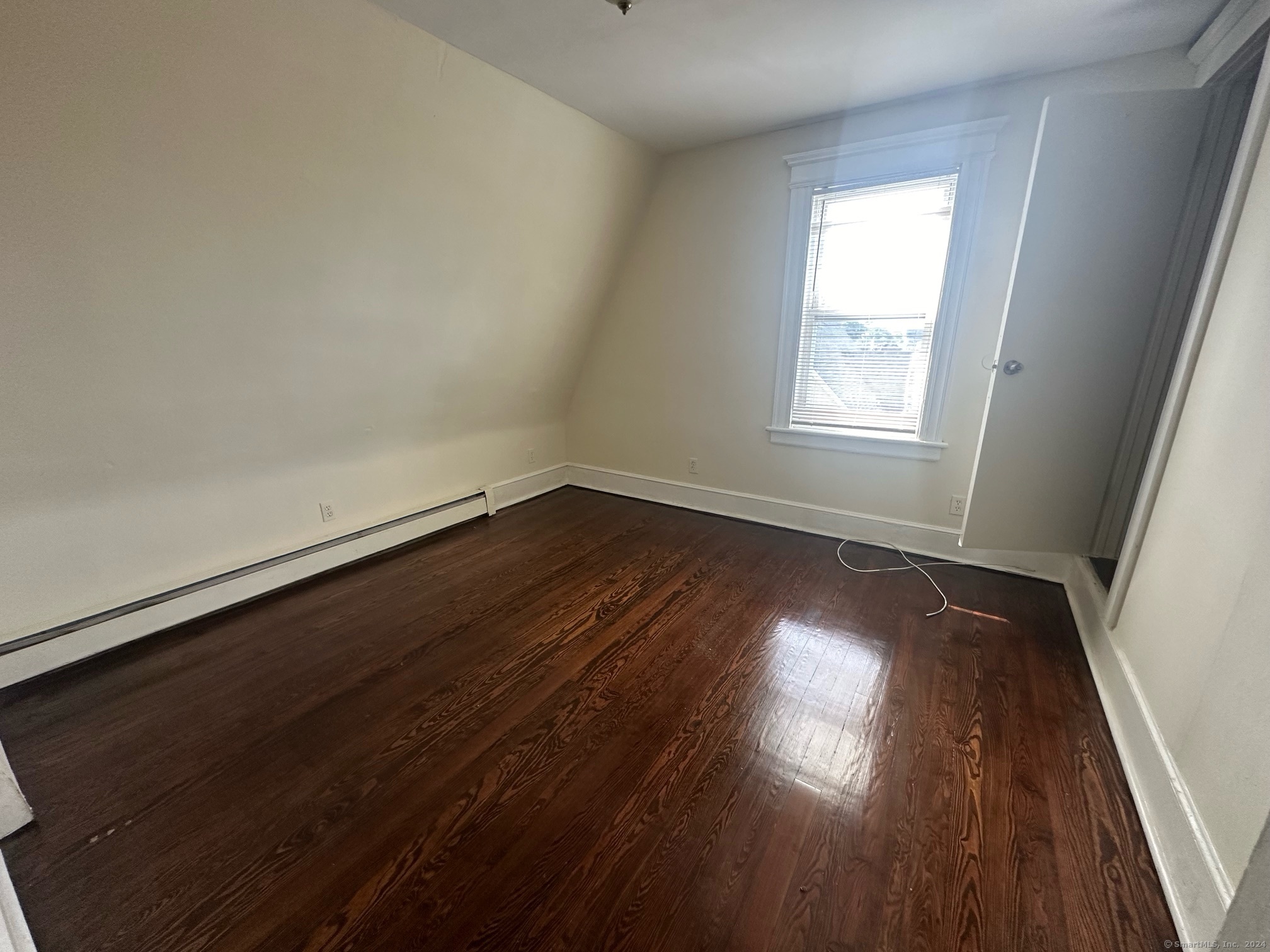 40 Vine Street, Unit 3 Bridgeport, CT 06604 - Photo 5 of 14 an empty room with wooden floor and windows