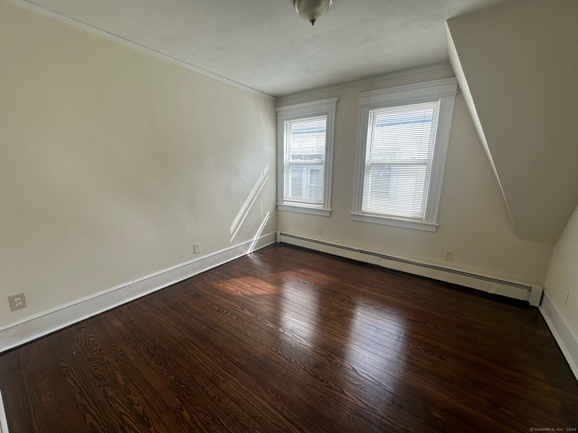 40 Vine Street, Unit 3 Bridgeport, CT 06604 - Photo 7 of 14 an empty room with wooden floor and windows