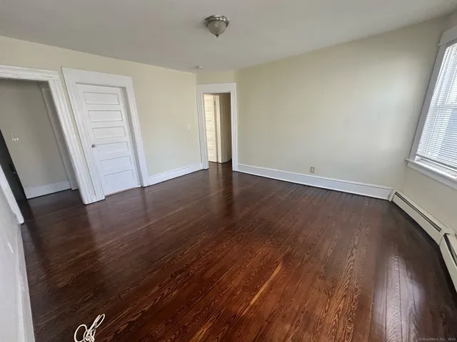 wooden floor in an empty room with a window