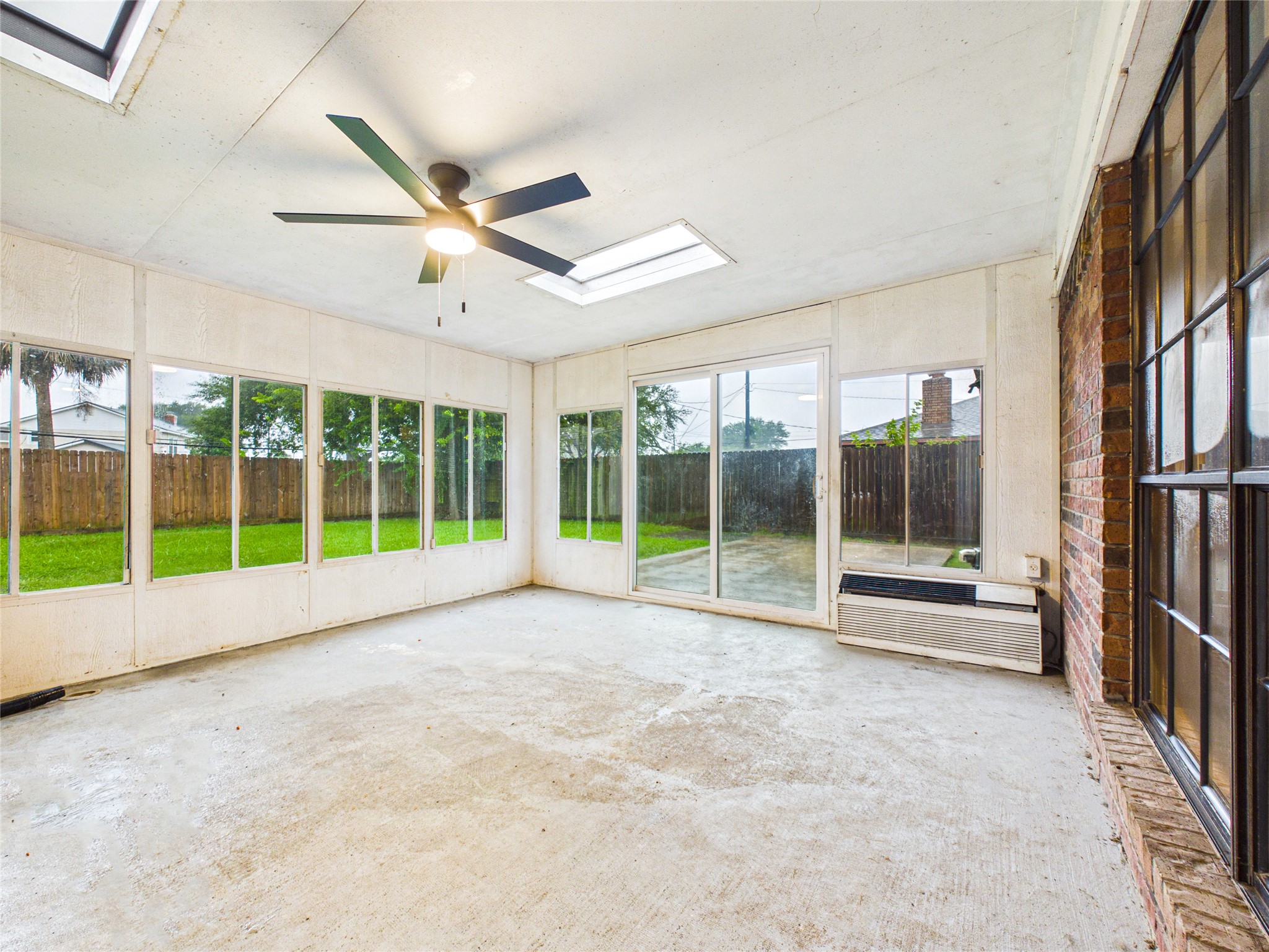 10306 Rustic Rock Road La Porte, TX 77571 - Photo 31 of 38 a view of an empty room with a floor to ceiling window and a ceiling fan