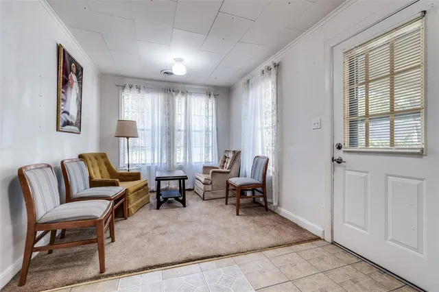 a living room with furniture and large windows