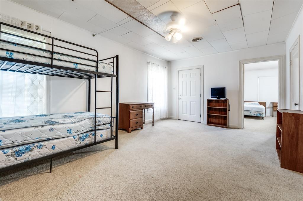 4501-4503 Highview Street Cockrell Hill, TX 75211 - Photo 15 of 24 a view of a bedroom with furniture and window