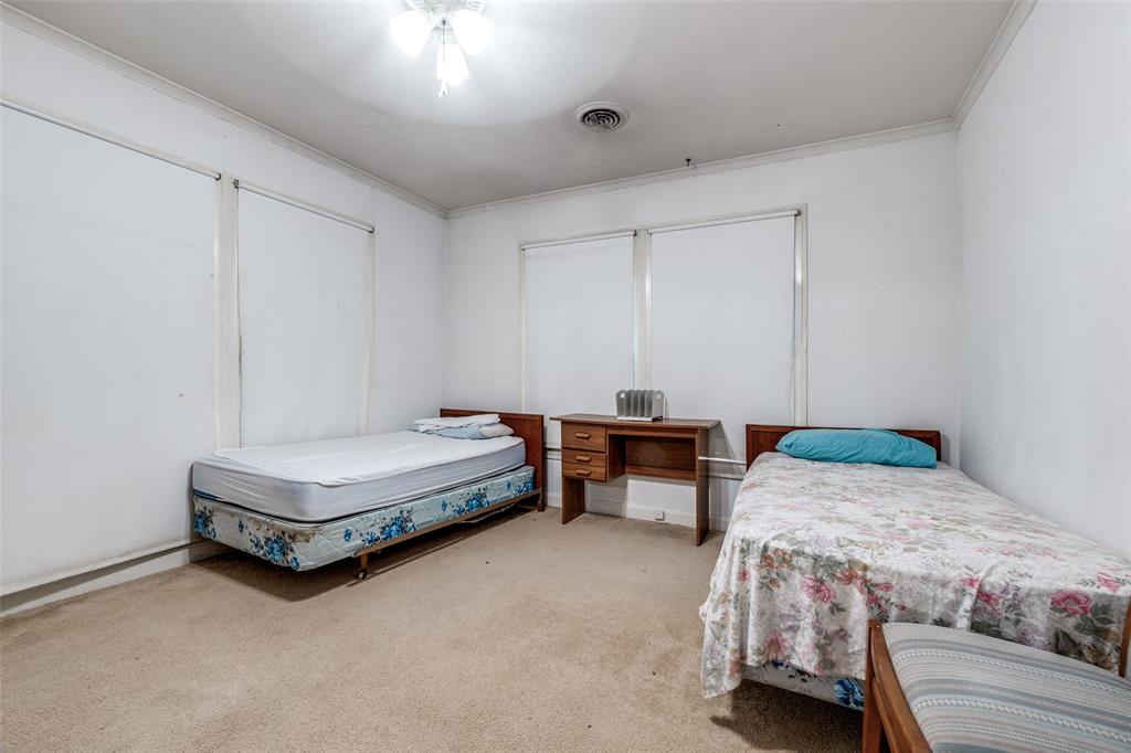 4501-4503 Highview Street Cockrell Hill, TX 75211 - Photo 17 of 24 a bedroom with a bed and a table in it