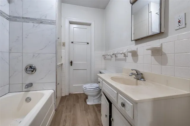 a bathroom with a sink a toilet and bathtub