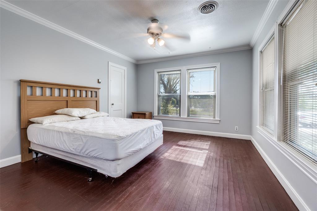 4501-4503 Highview Street Cockrell Hill, TX 75211 - Photo 19 of 24 a bedroom with a large bed and a window