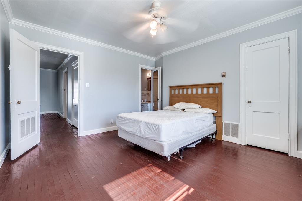 4501-4503 Highview Street Cockrell Hill, TX 75211 - Photo 20 of 24 a bedroom with a bed and a chandelier