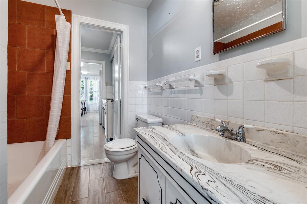 4501-4503 Highview Street Cockrell Hill, TX 75211 - Photo 21 of 24 a bathroom with a sink a toilet and shower