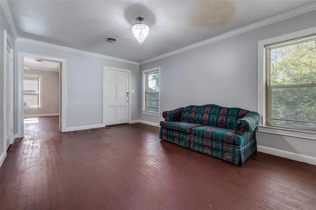 a living room with furniture and a chandelier