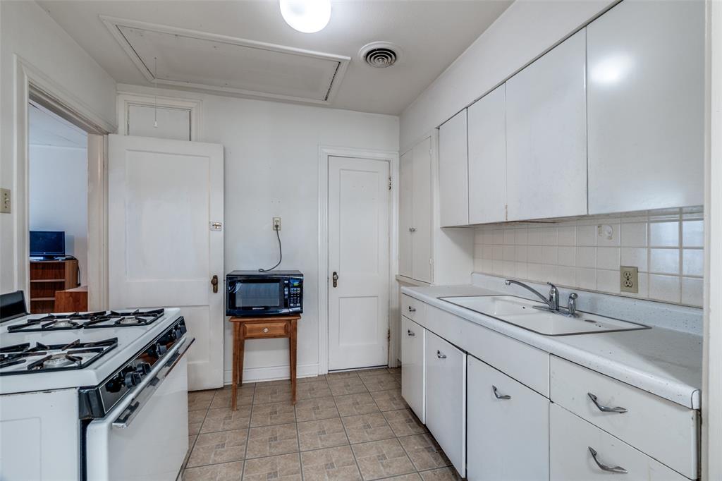 4501-4503 Highview Street Cockrell Hill, TX 75211 - Photo 8 of 24 a kitchen with stainless steel appliances granite countertop a sink stove and cabinets
