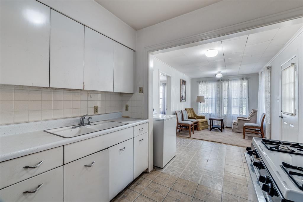 4501-4503 Highview Street Cockrell Hill, TX 75211 - Photo 9 of 24 a kitchen with sink refrigerator and cabinets