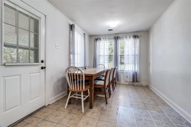 a view of a dining room with furniture and window