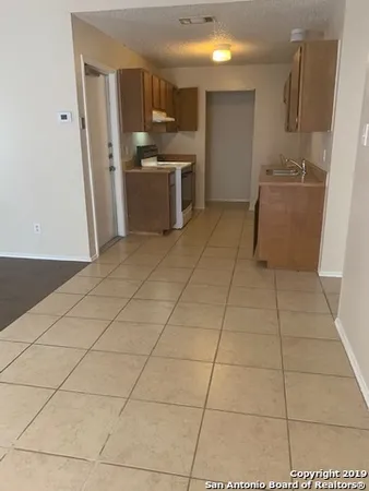 a kitchen with stainless steel appliances a sink and cabinets